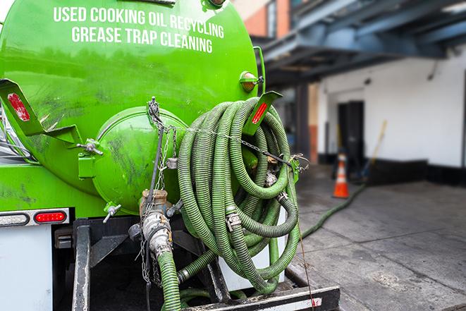 grease trap pumping truck in action in Altadena